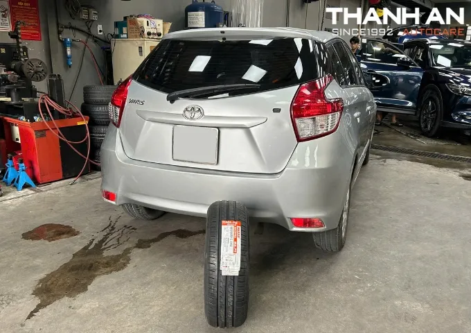 Xe Toyota Yaris đang được n&acirc;ng l&ecirc;n để thay lốp mới tại gara