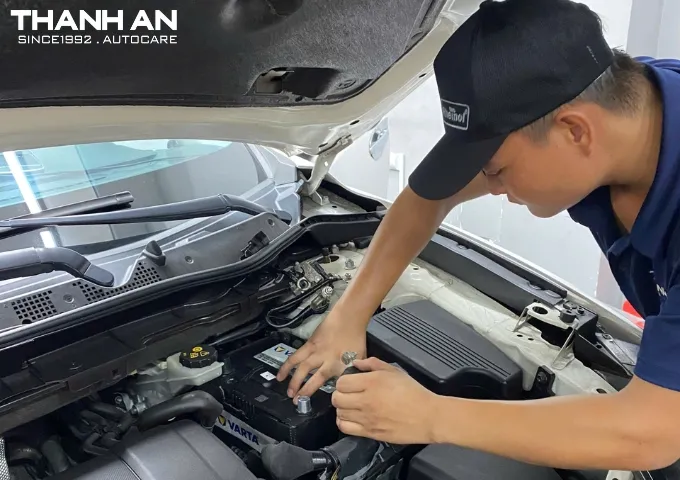Kỹ thuật viên thay bình ắc quy Varta cho xe ô tô tại gara tphcm